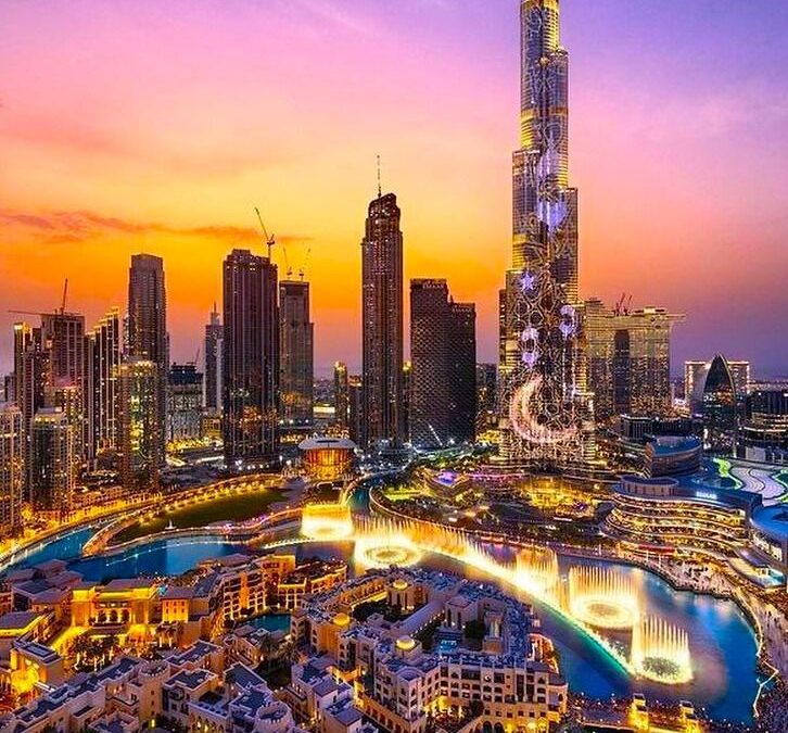 Dubai skyline featuring Burj Khalifa at sunset in Dubai United Arab Emirates.