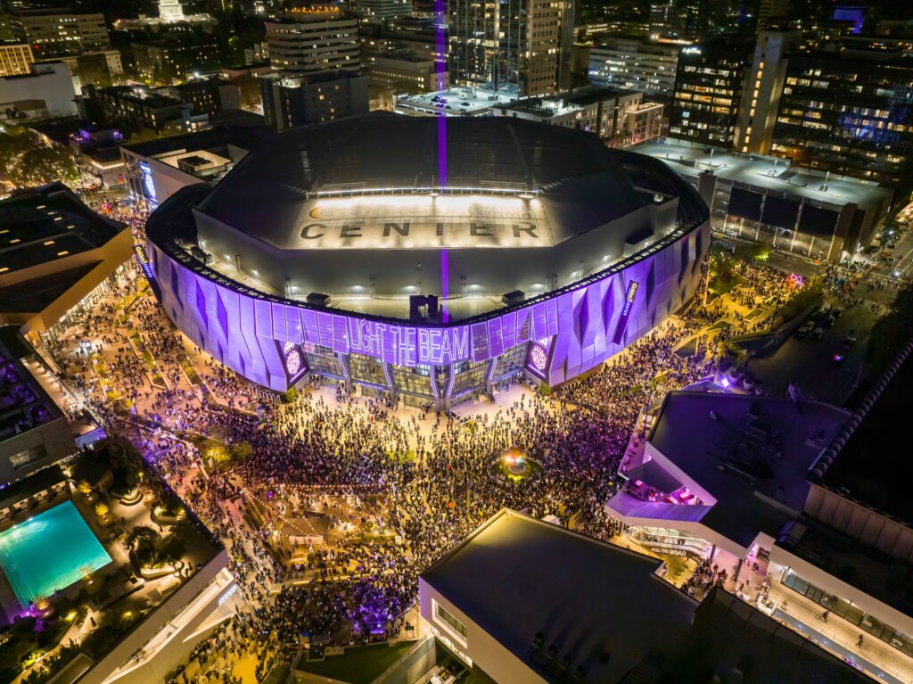Aerial view of fans gathered outside a sports arena at night, illustrating the excitement and community spirit that championship celebrations inspire.